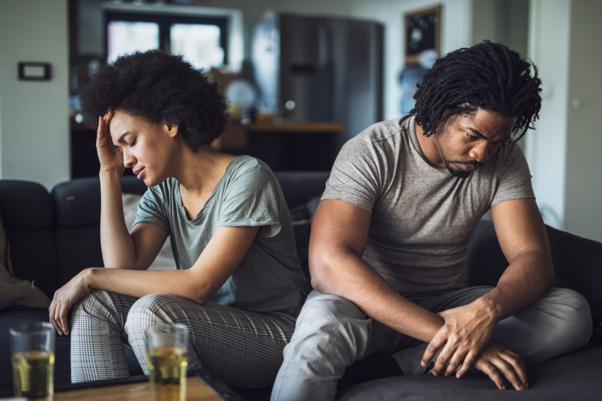 Husband and wife frustrated on a couch