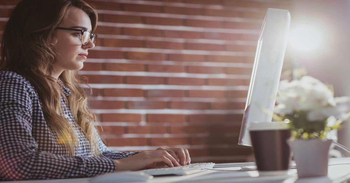 woman at desk working on computer